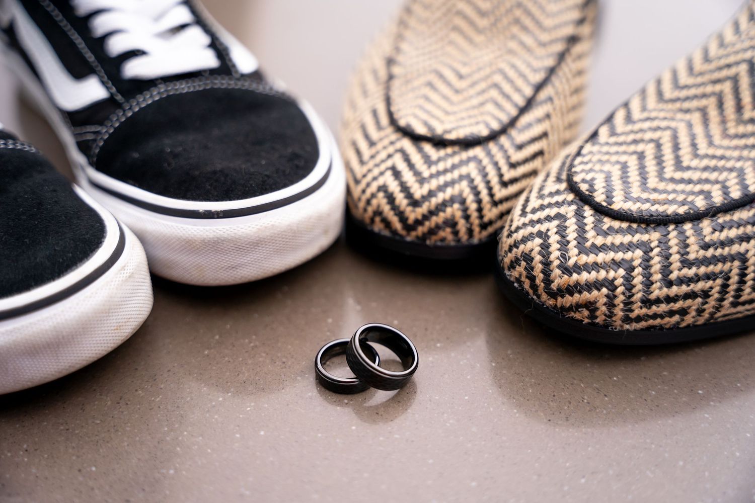 Wedding rings displayed next to brown and white chevron patterned accessories.