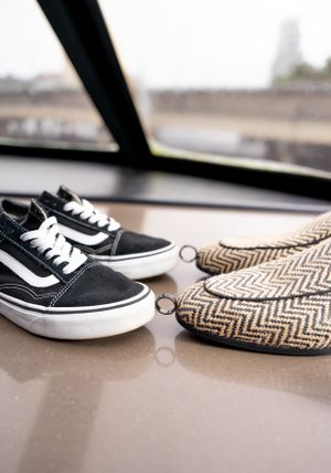 Black and white sneakers paired with chevron patterned fabric and wedding rings.