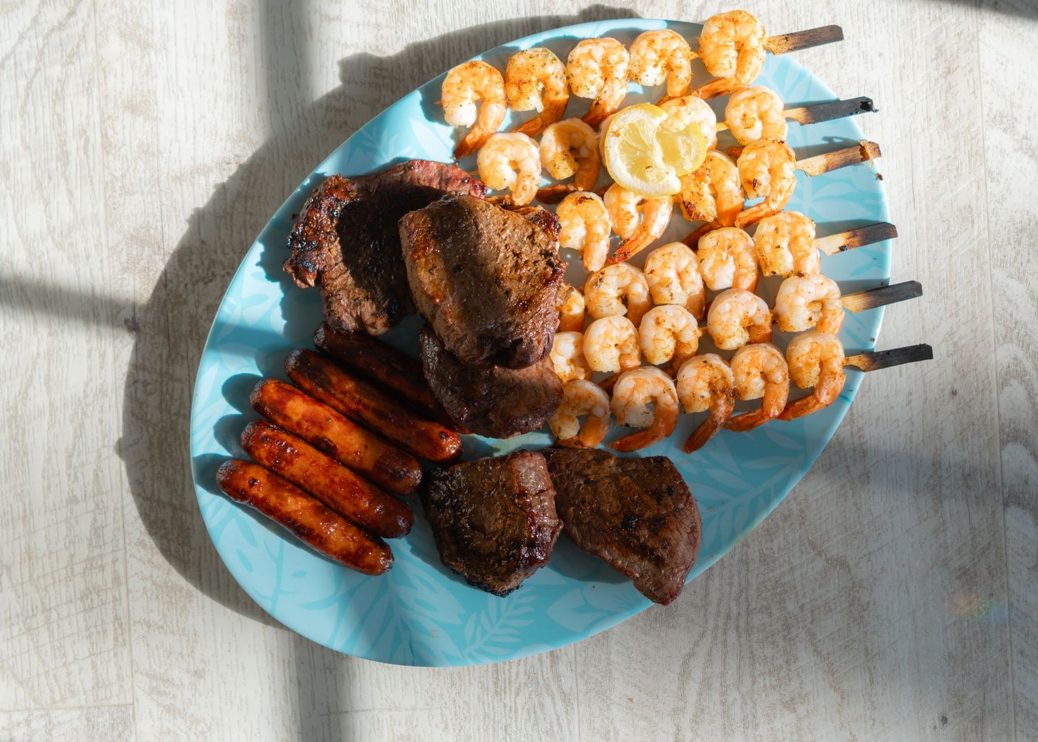 summer grill platter of hot dogs, steak, and grilled shrimp
