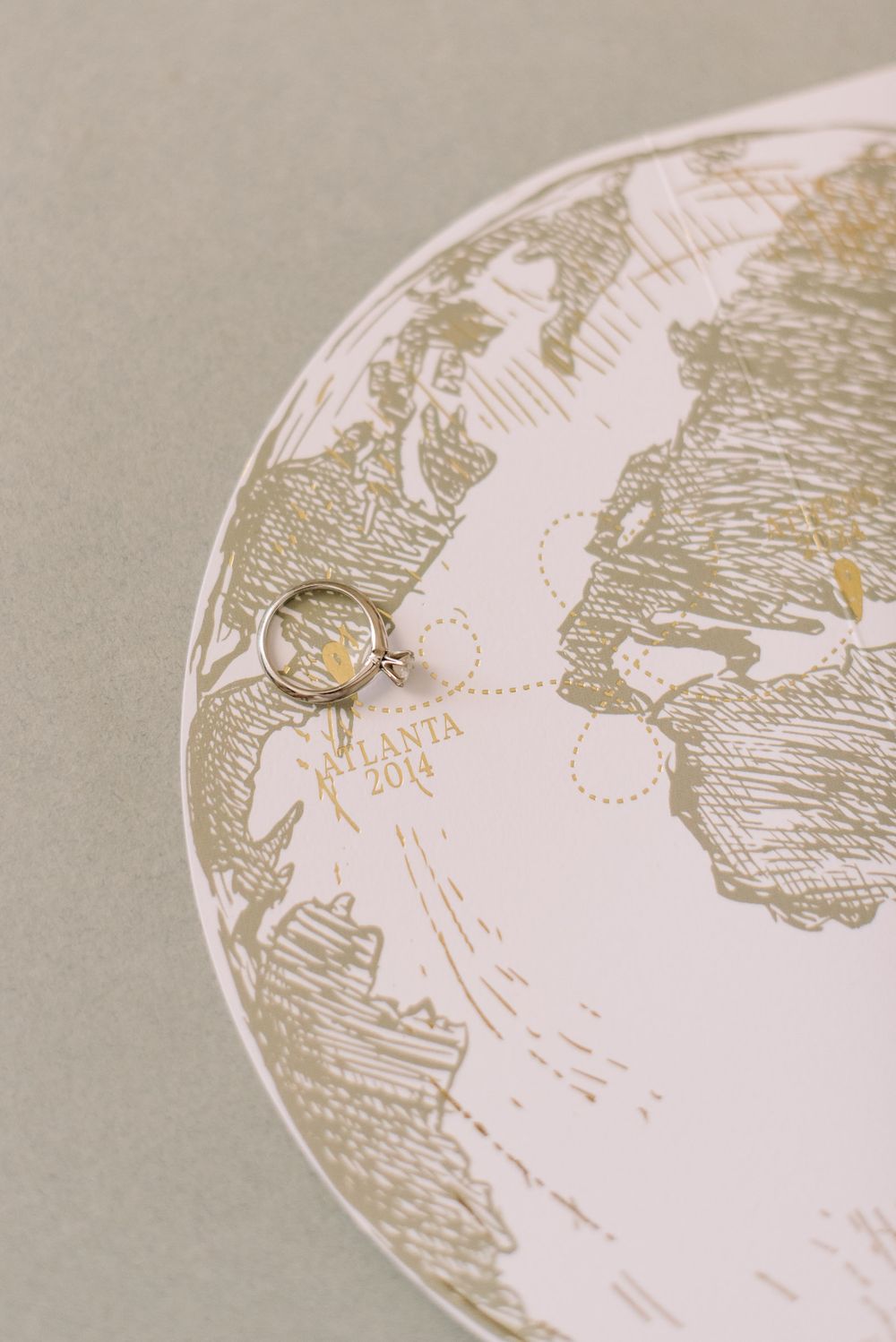 A close-up series showing progressive detail shots of an etched or engraved circular design in gold on white paper.