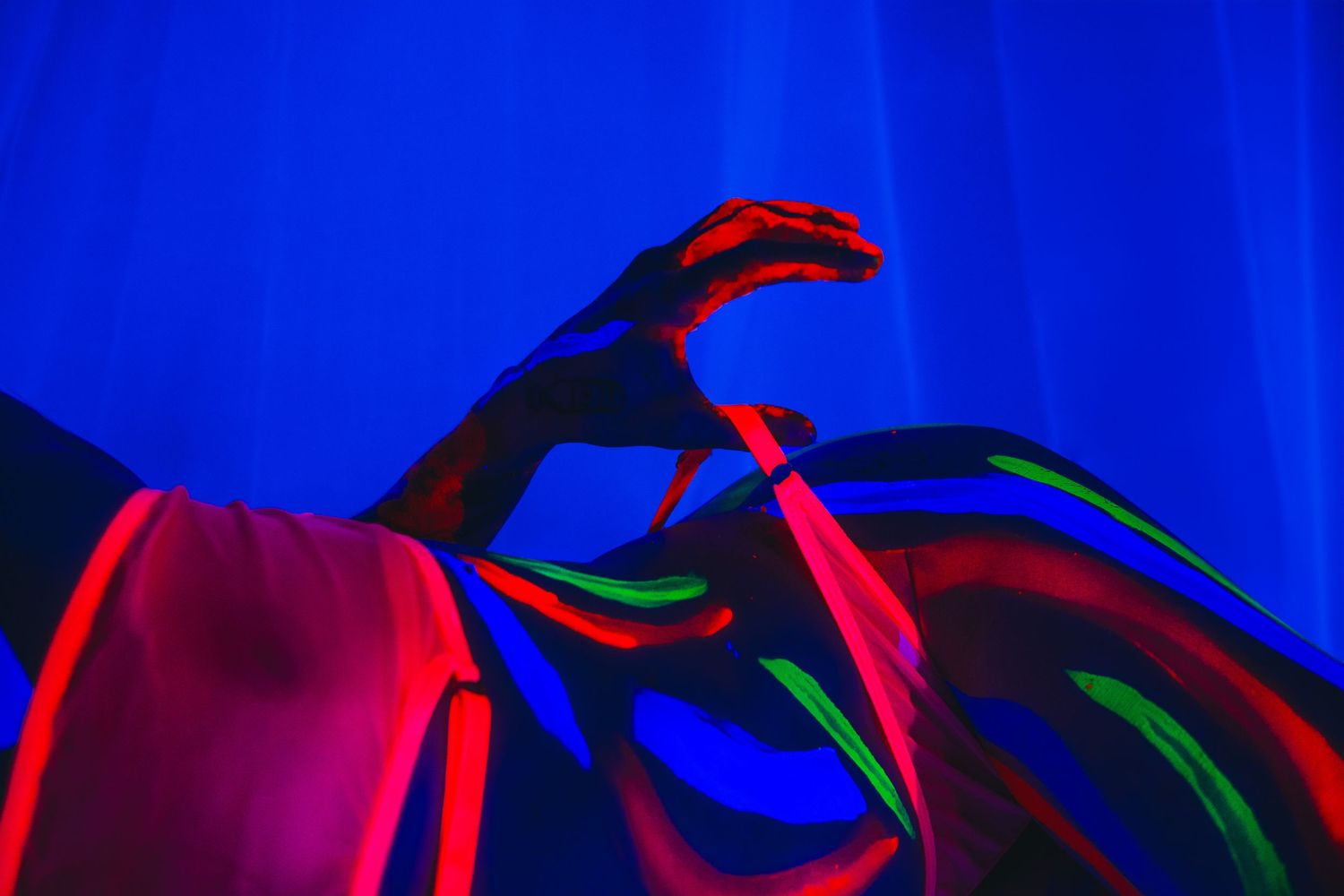 Black Light boudoir session featuring artistic neon paint.
