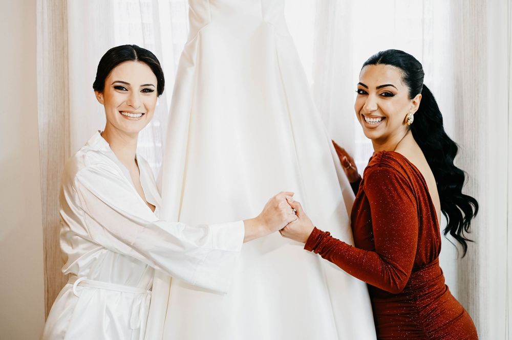 A series of getting ready photos showing a woman in a maroon sweater and white dress against a bright background.