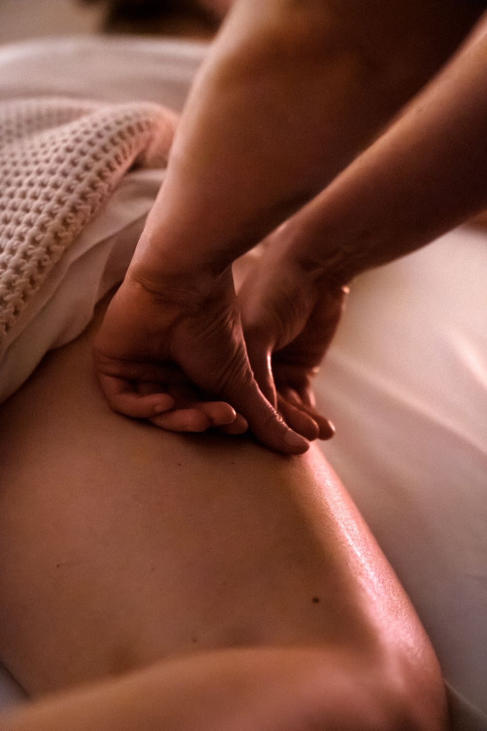 Deep tissue massage techniques demonstrated on back muscles.