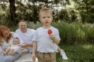 A collection of candid family moments captured outdoors in a natural garden setting during a photo session.