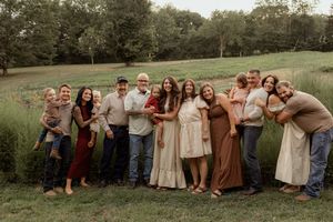 A series of outdoor family photos taken in a grassy field with people wearing casual and earth-toned clothing.