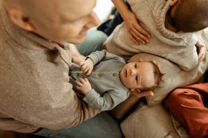 A series of tender moments between parent and baby during a lifestyle photoshoot in soft, neutral tones.