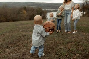 A collection of outdoor family photos showing candid moments on a hillside during autumn.
