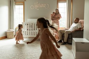 A collection of soft, dreamy photographs showing tender moments between parent and child in a light-filled nursery.