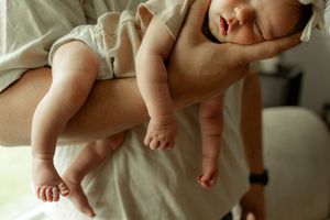 A collection of baby photos showing tiny feet and legs against various light backgrounds.