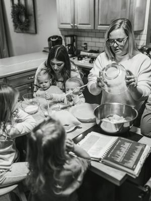 A series of black and white photographs showing adults and children looking at books together in an educational setting.