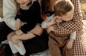 A series of intimate sepia-toned photographs showing tender moments between couples in vintage-style clothing.