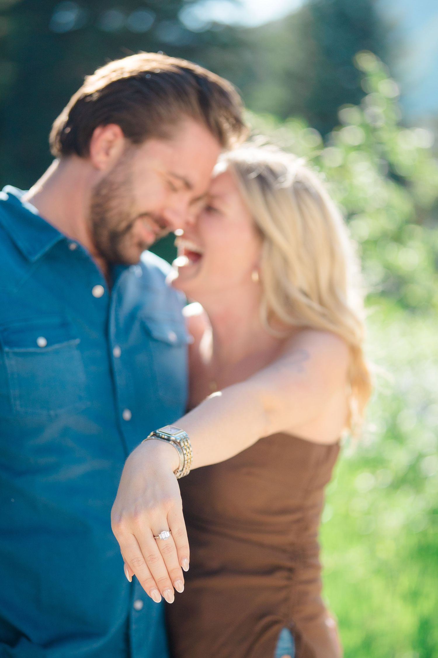 guy and girl showing off engagement ring