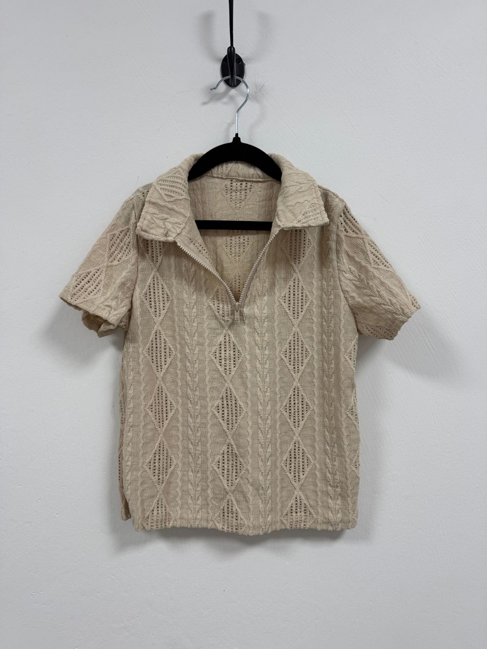 Beige knit cropped sweater with collared neckline and cable knit pattern shown from multiple angles on hangers.