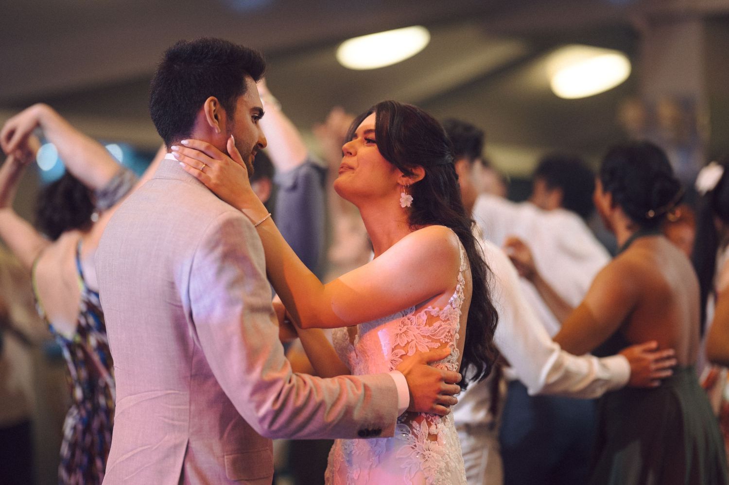 Couples dance closely together during an intimate reception celebration.
