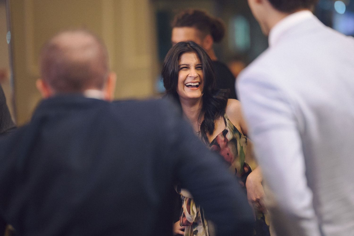 Party guests share laughs and smiles during a joyful celebration.