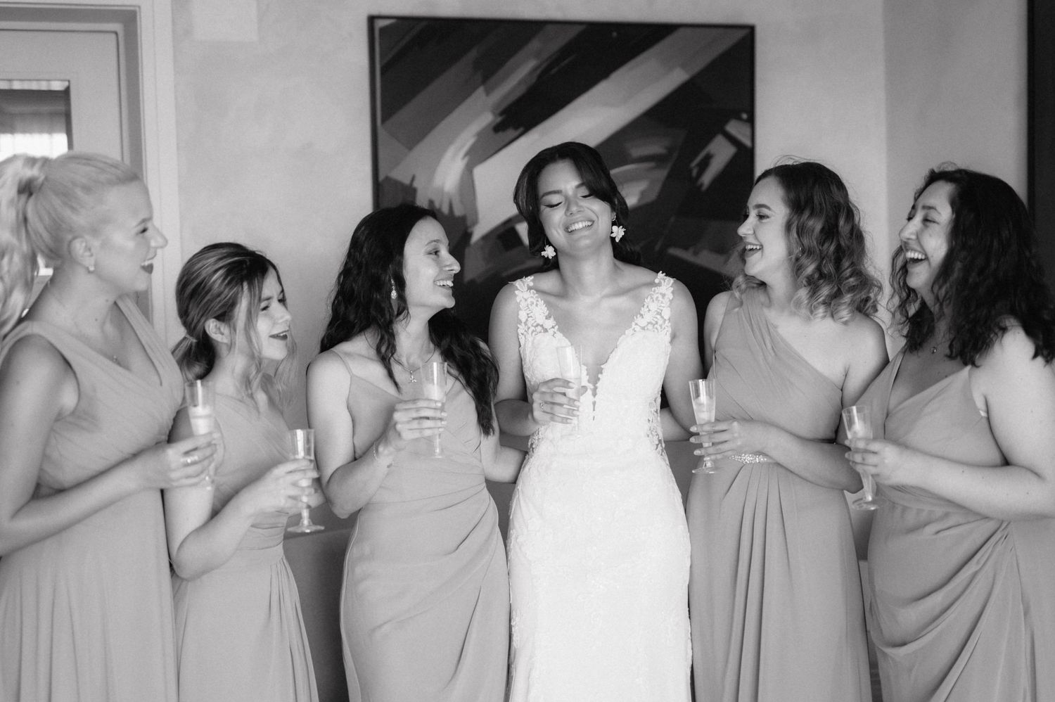 Wedding party wearing light colored dresses reacts with joy and laughter during a candid photo sequence.