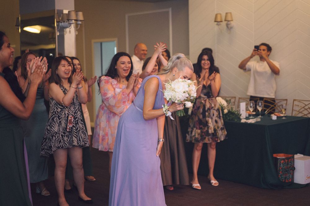 Guests at a wedding reception dance and celebrate together on the dance floor.