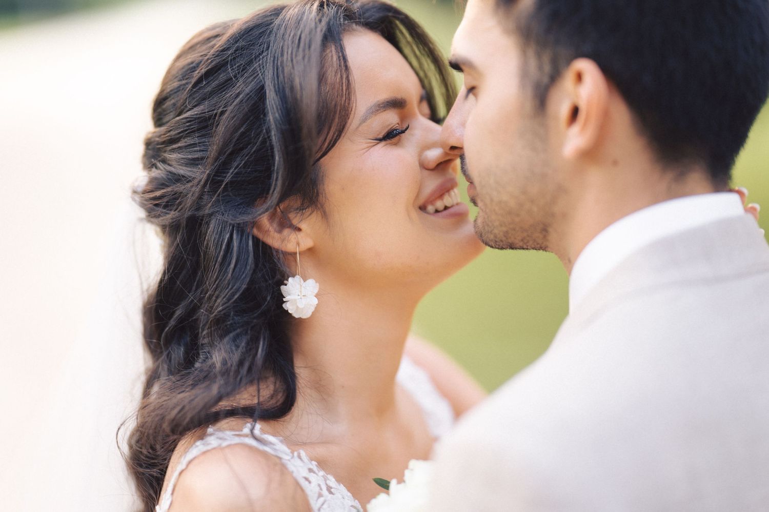 A romantic wedding photo collage showing four intimate moments between newlyweds in an outdoor garden setting.