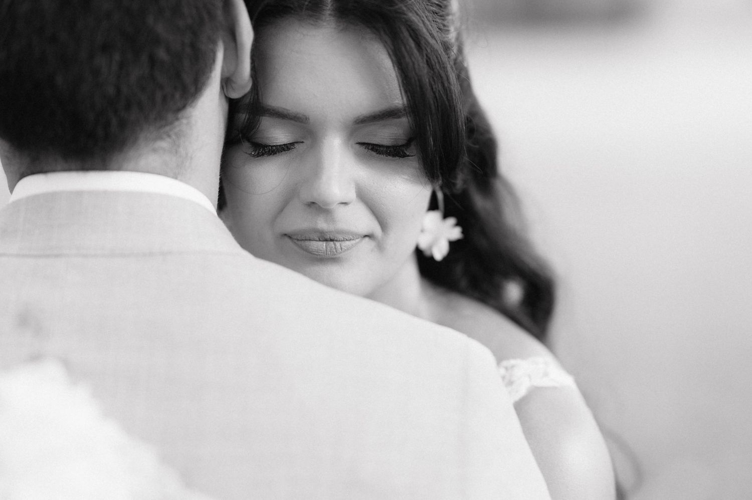 Black and white wedding photography collage showing intimate candid moments and details between the bride and groom.