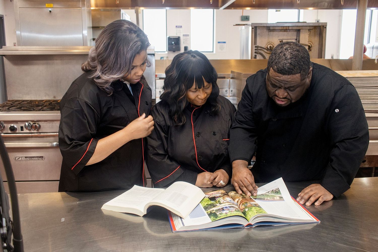 People studying together at a table with books and educational materials.