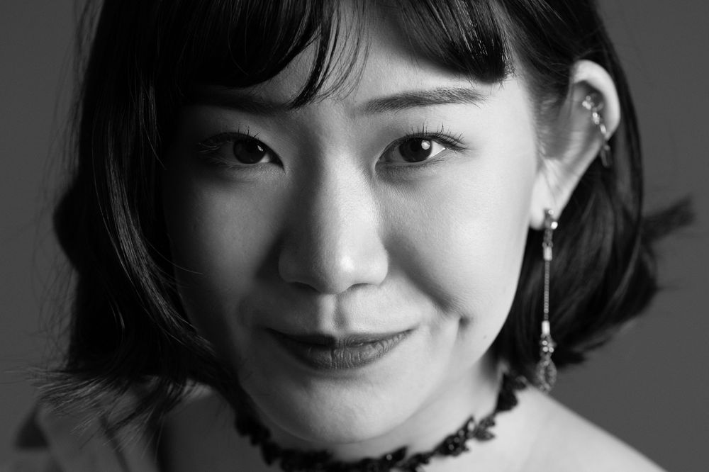 A series of black and white portrait photographs showing different expressions and emotions in a minimalist style.