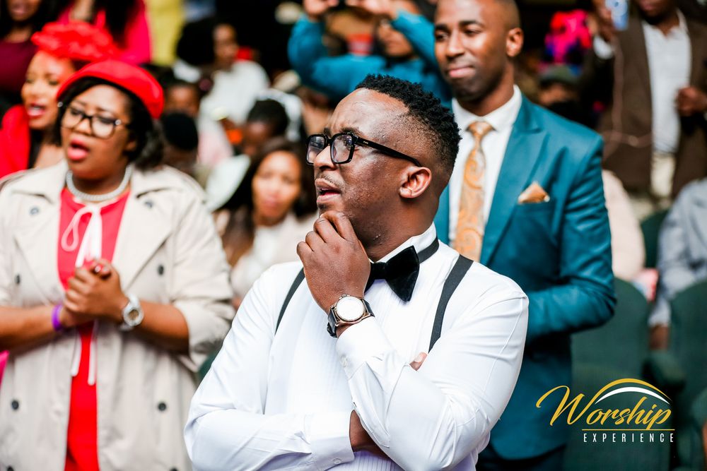 “Gospel concert crowd in worship”
