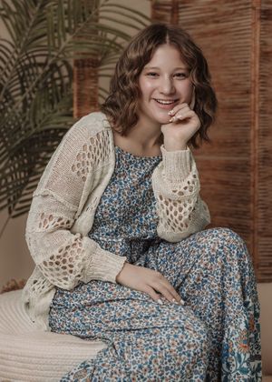 Fashion series showcasing blue floral dress with crochet cardigan against bamboo screen backdrop.