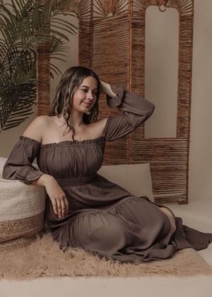 Relaxed portrait series in chocolate brown dress against natural bamboo screen and fluffy rug.