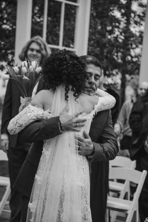 Dad hugging his daughter on wedding day