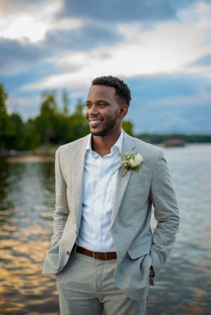 Groom in front of sunset on the lake