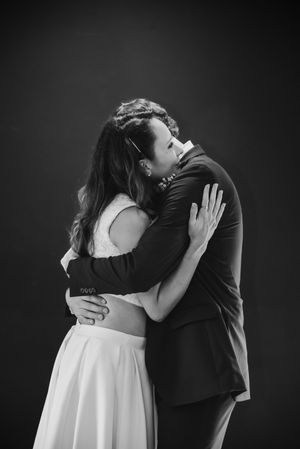 Bride and groom, hugging, black-and-white photo