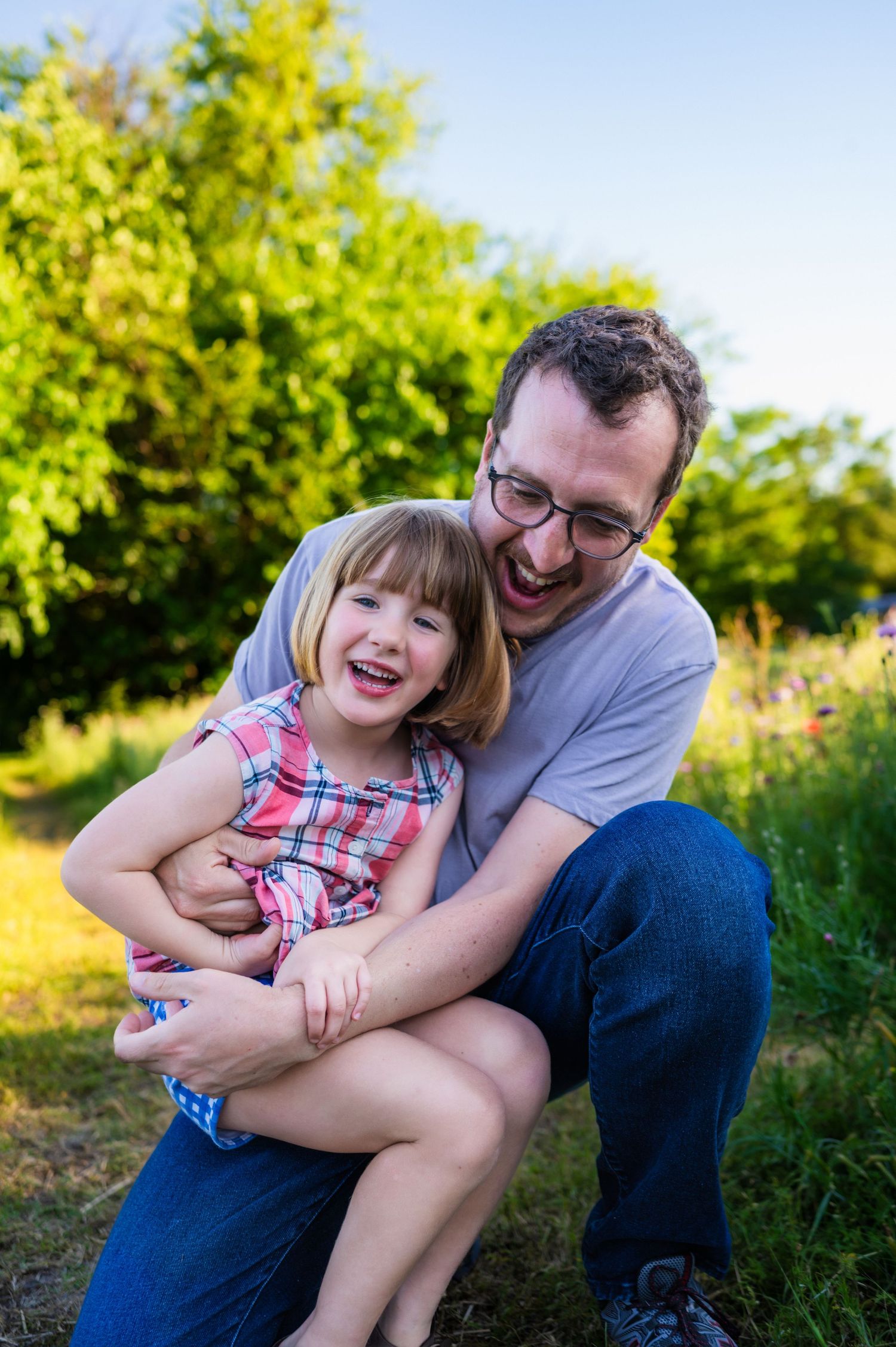 Dad and daughter during dallas area family mini session, dad kneeling to preschool aged daughters level