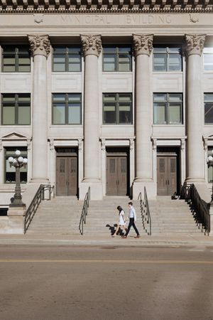 Architectural sequence showing progressively zoomed out views of a neoclassical building entrance with ornate columns.