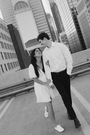 A black and white photo sequence showing two people in formal attire walking and interacting along a city sidewalk.