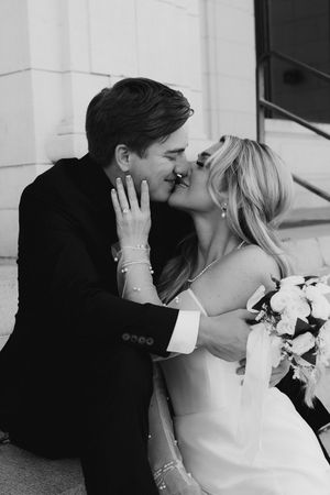 A stylish black and white wedding photo sequence showing an intimate romantic kiss at an elegant venue.