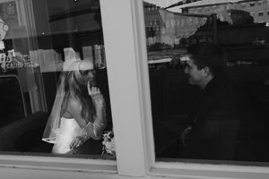 Multiple silhouettes reflected in a series of glass windows showing a blurry urban scene.