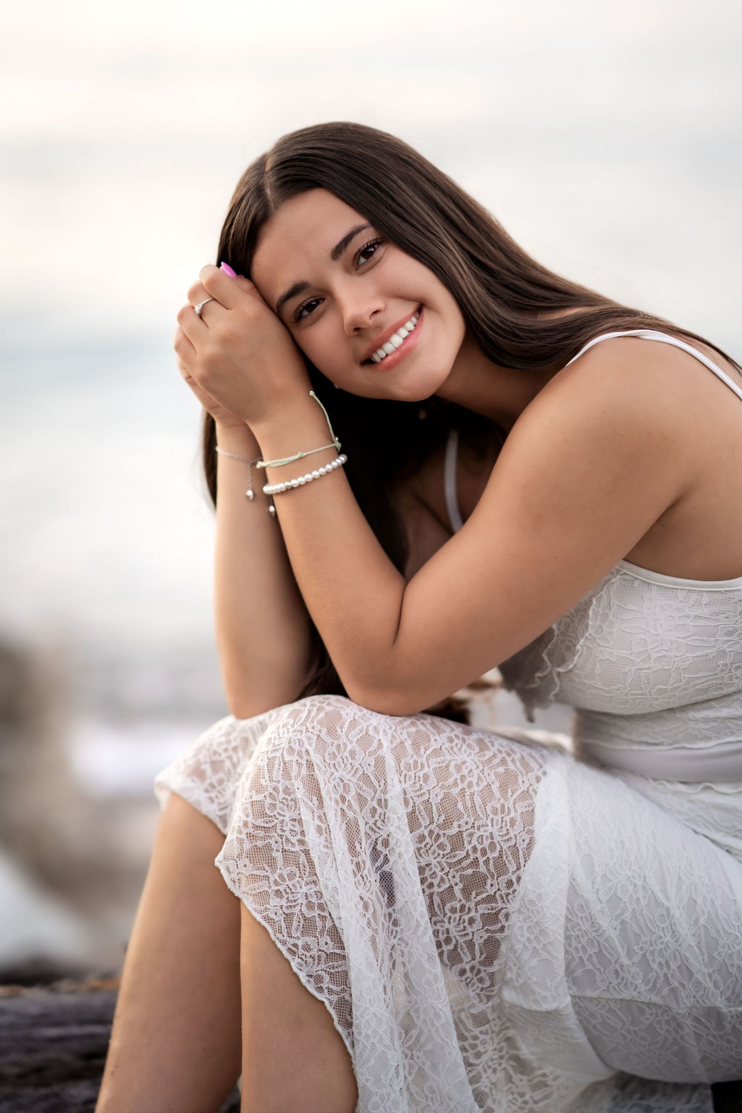 Elegant series in white lace dress featuring relaxed poses on natural wood with soft lighting.