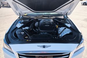 Modern car engine bay showing clean and detailed Genesis motor components under an open hood.