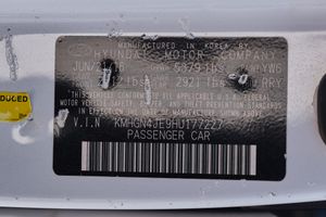 Vehicle information sticker with barcode and specifications mounted on car body.