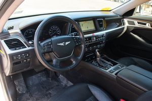 Modern luxury car interior featuring leather steering wheel, digital displays and premium materials.
