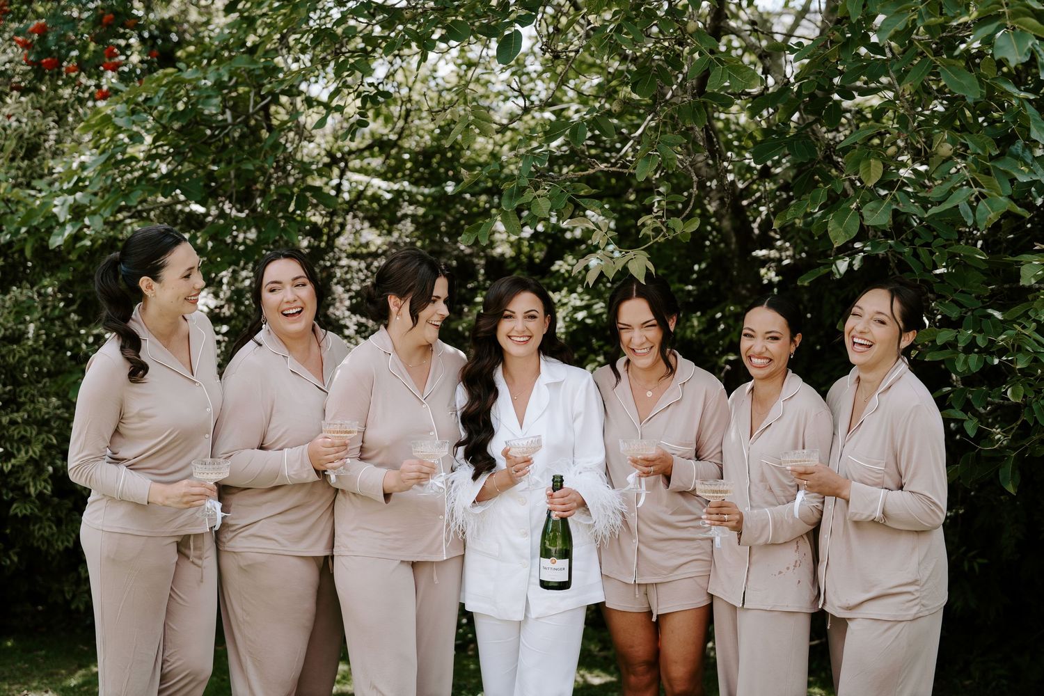 bride popping champagne with bridesmaids at the new inn cirencester