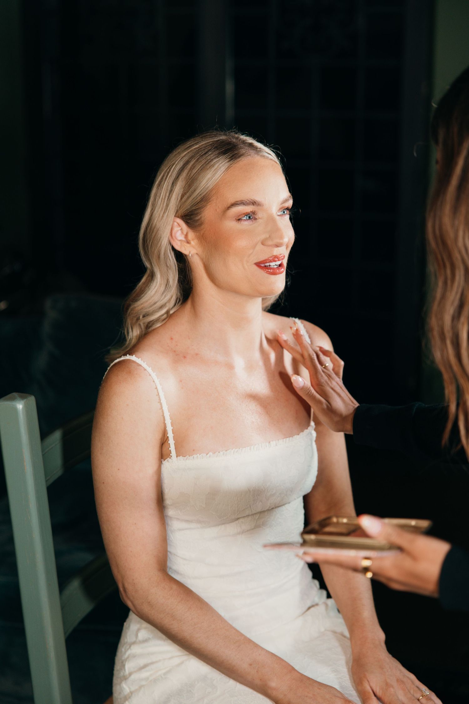A close-up getting ready shot showing final wedding day makeup preparations.