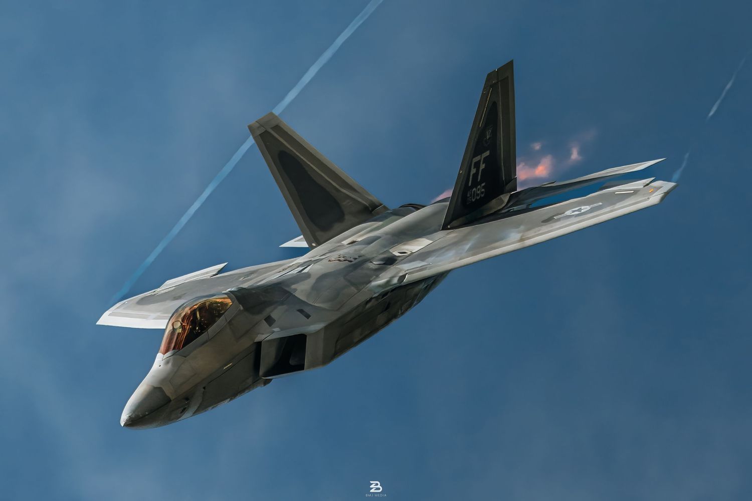 USAF F-22 Raptor jet in a high-speed dive maneuver