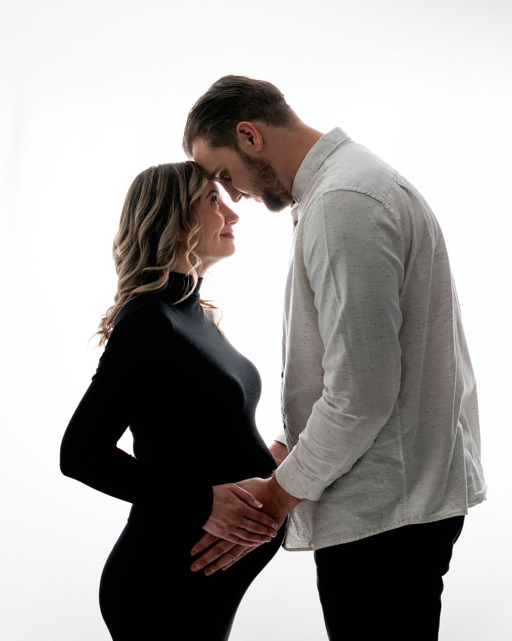 A series of silhouettes show a couple in black and white expressing emotional moments together against a light background.