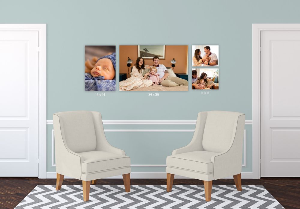 Two elegant cream-colored upholstered armchairs with wooden legs sit against a light blue wall in a modern living room.