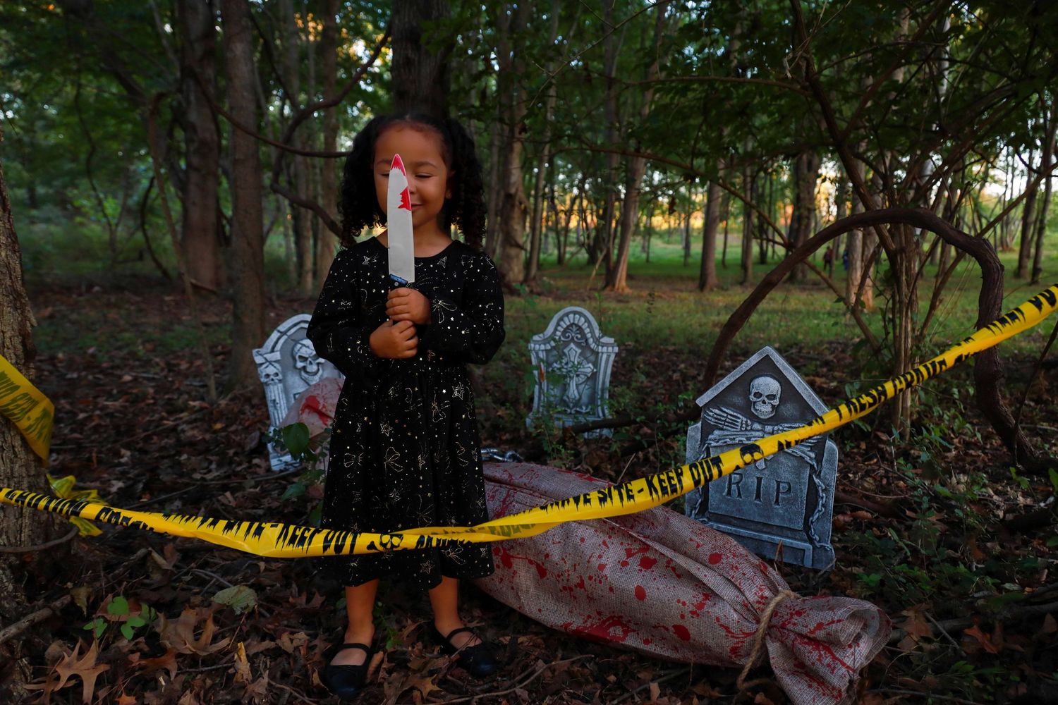 A series of police tape-marked crime scene photos showing evidence markers and investigators in a wooded area.