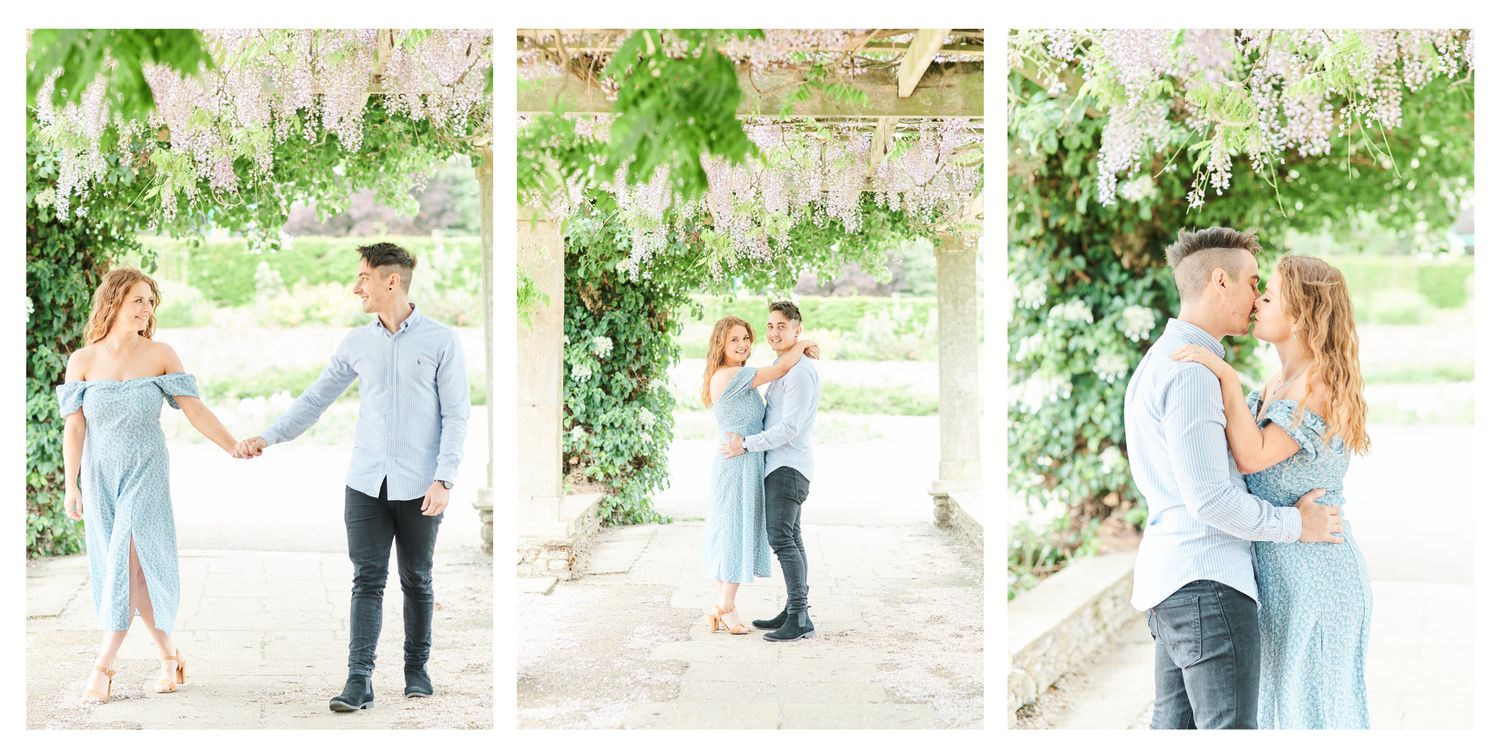 couple kiss under wisteria at Waterloo Park in Norfolk by Norwich's best engagement photographer Faye Amare