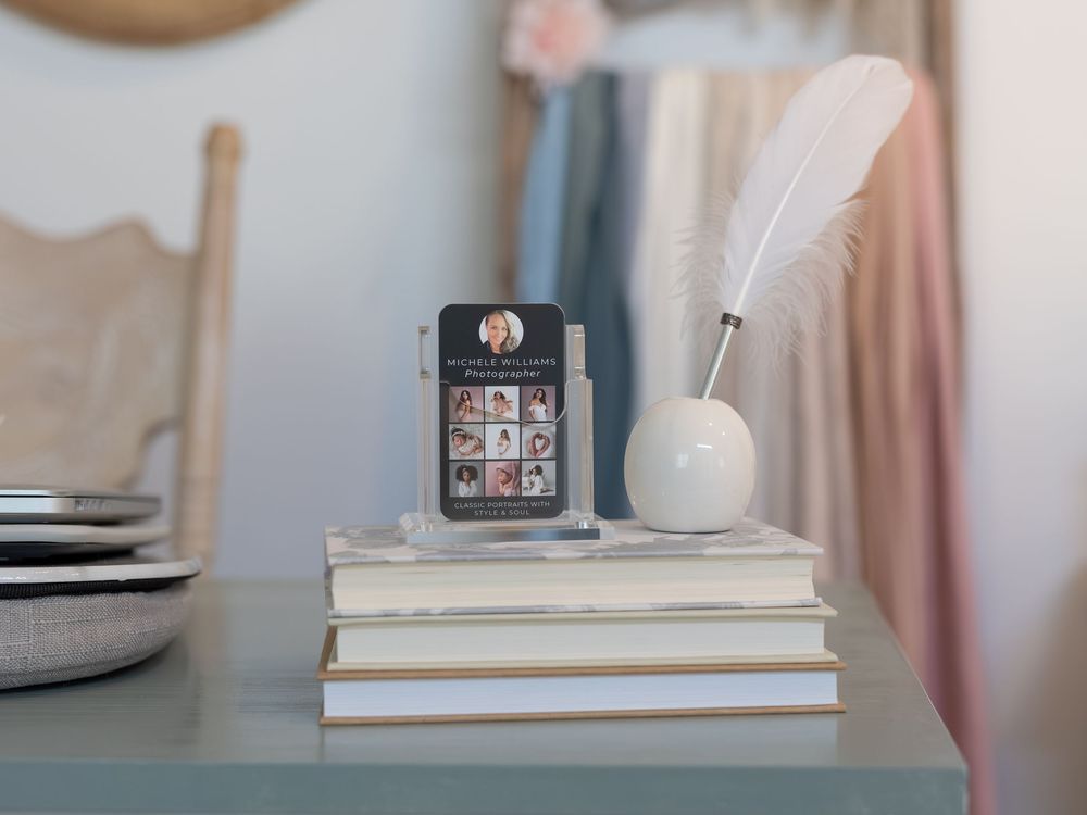 Elegant home office setup with white desk, books, and pink curtains creating a soft, feminine workspace atmosphere.
