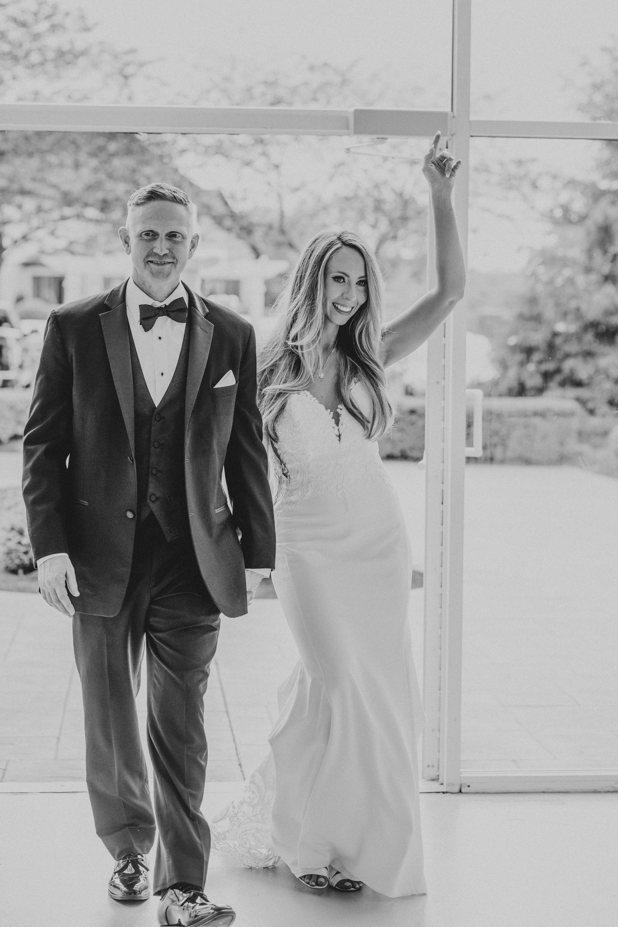 Black and white wedding photos showing couple dancing together in formal attire on their special day.