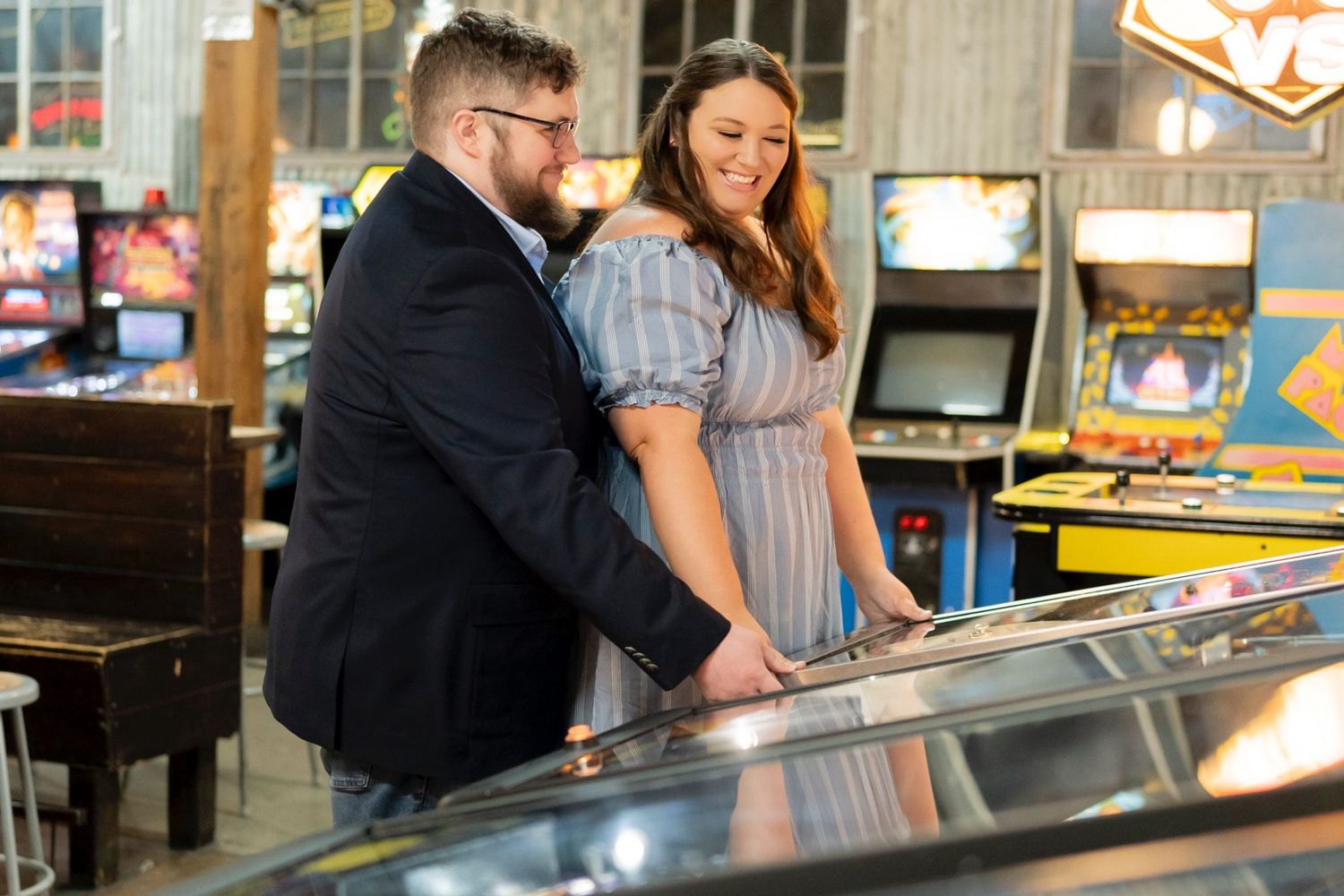 Fun engagement portrait photographed with the Sony A7iii in an indoor arcade setting